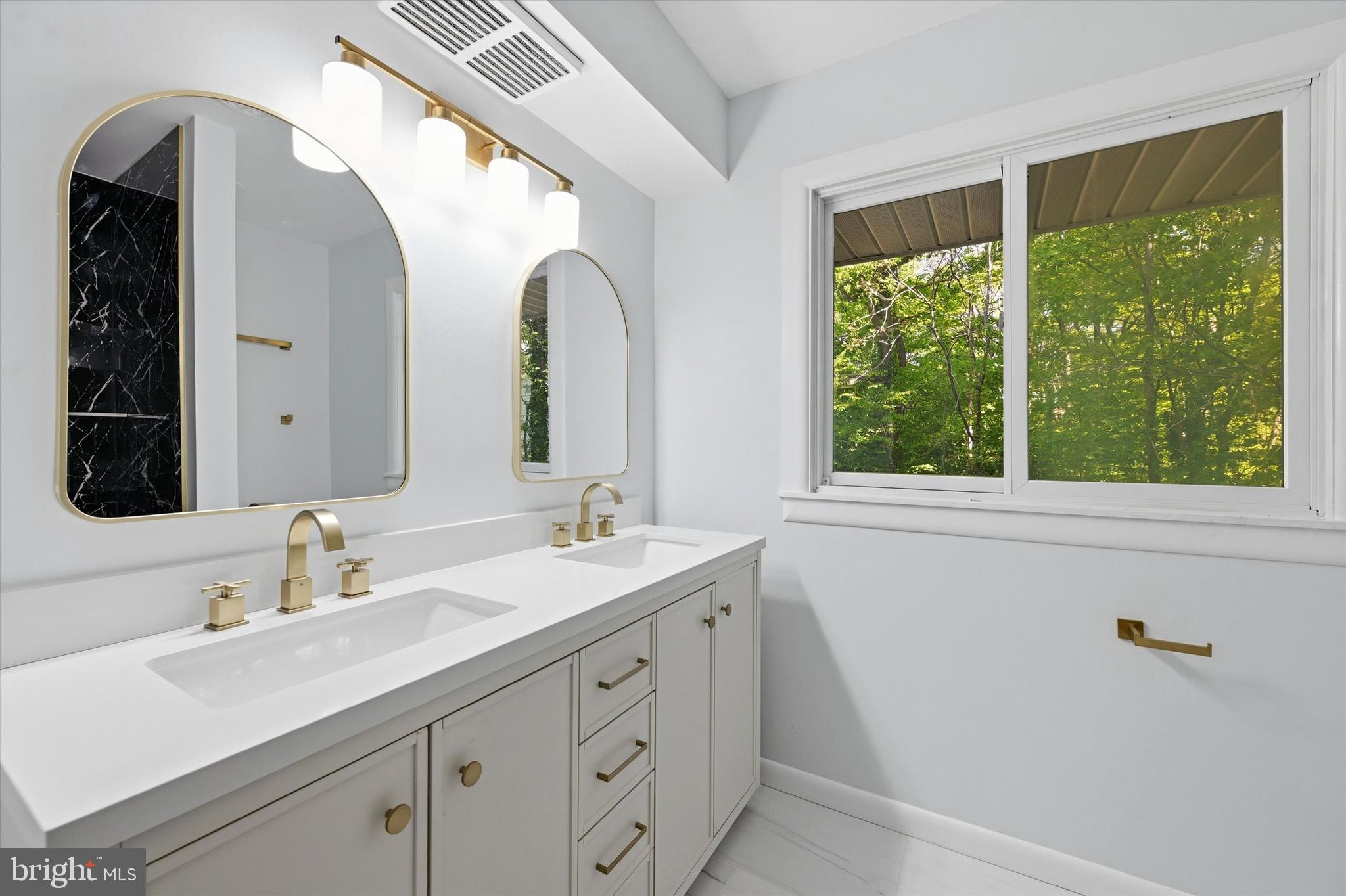 103 Baynard Boulevard Wilmington, DE 19803 - Photo 21 of 35 a bathroom with a double vanity sink and mirror with window