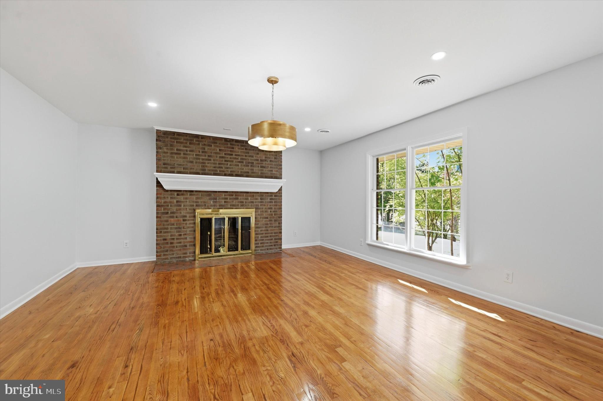 103 Baynard Boulevard Wilmington, DE 19803 - Photo 6 of 35 a view of an empty room with a fireplace and a window
