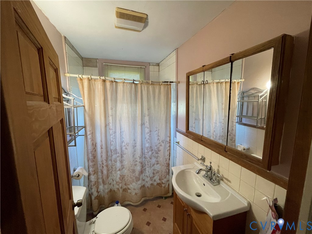 4667 Bell Road Powhatan, VA 23139 - Photo 6 of 10 a bathroom with a sink toilet and shower