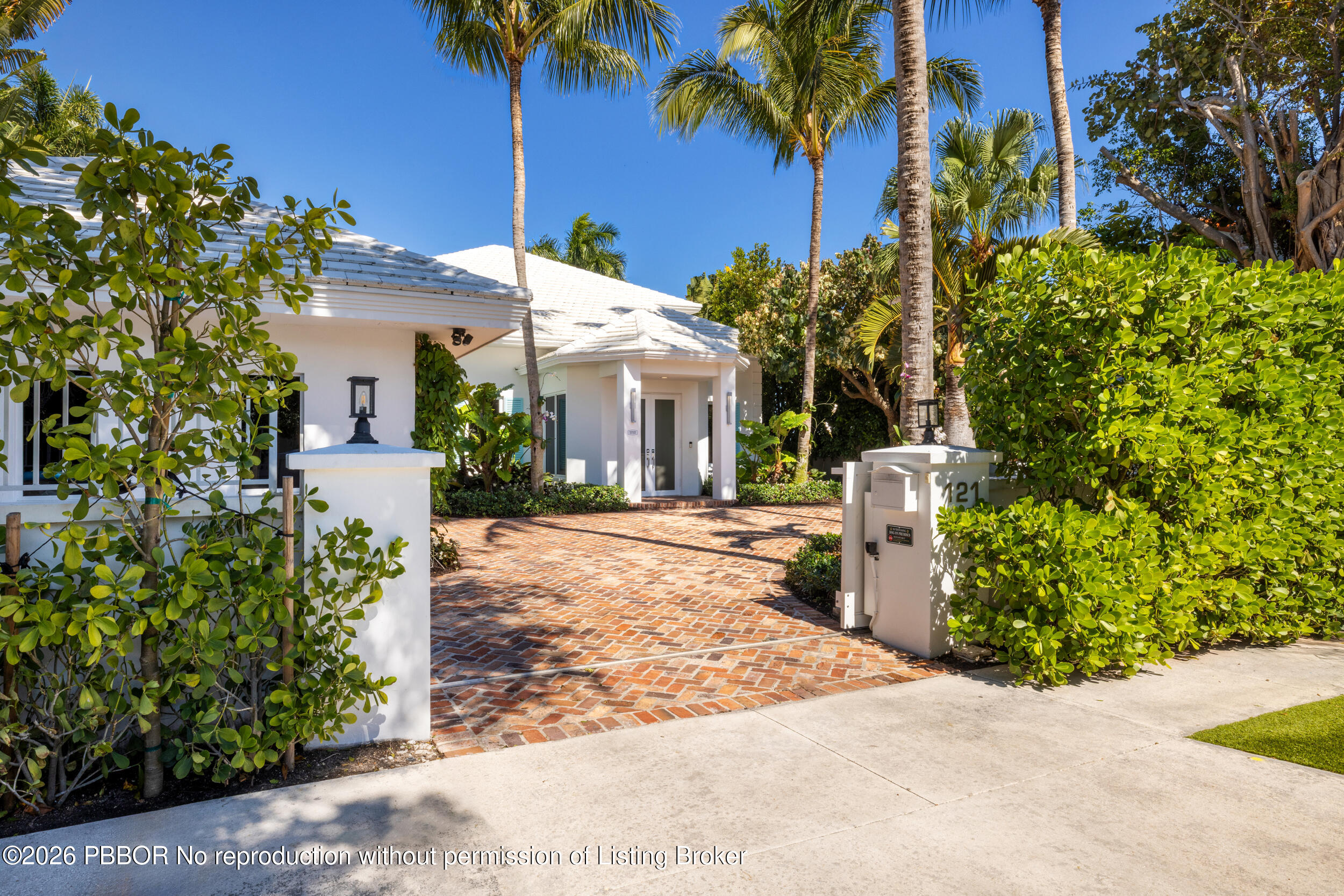 121 Seville Road West Palm Beach, FL 33405 - Photo 6 of 67 a front view of a house with a yard and potted plants