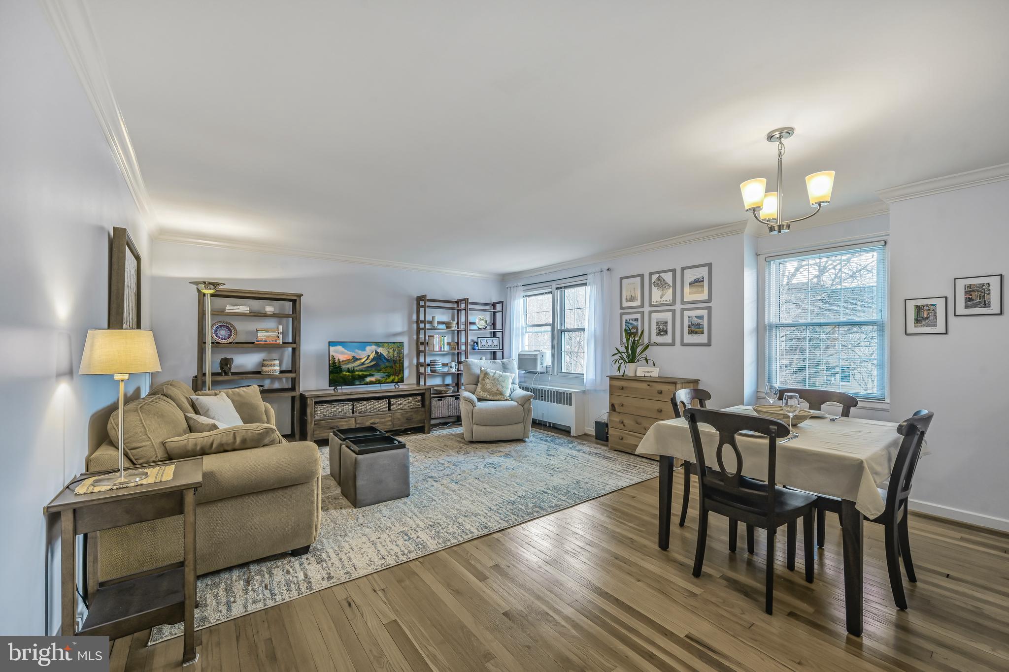 2402 Colston Drive, Unit 204 Silver Spring, MD 20910 - Photo 1 of 13 a living room with furniture and wooden floor