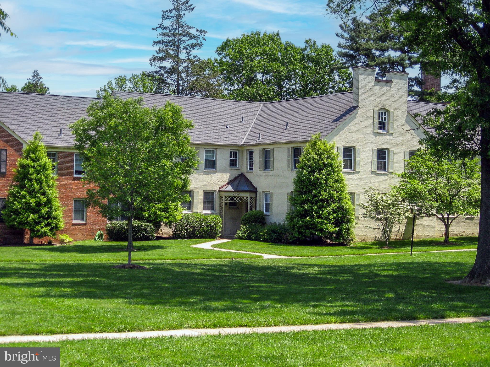2402 Colston Drive, Unit 204 Silver Spring, MD 20910 - Photo 2 of 13 a front view of a house with a yard