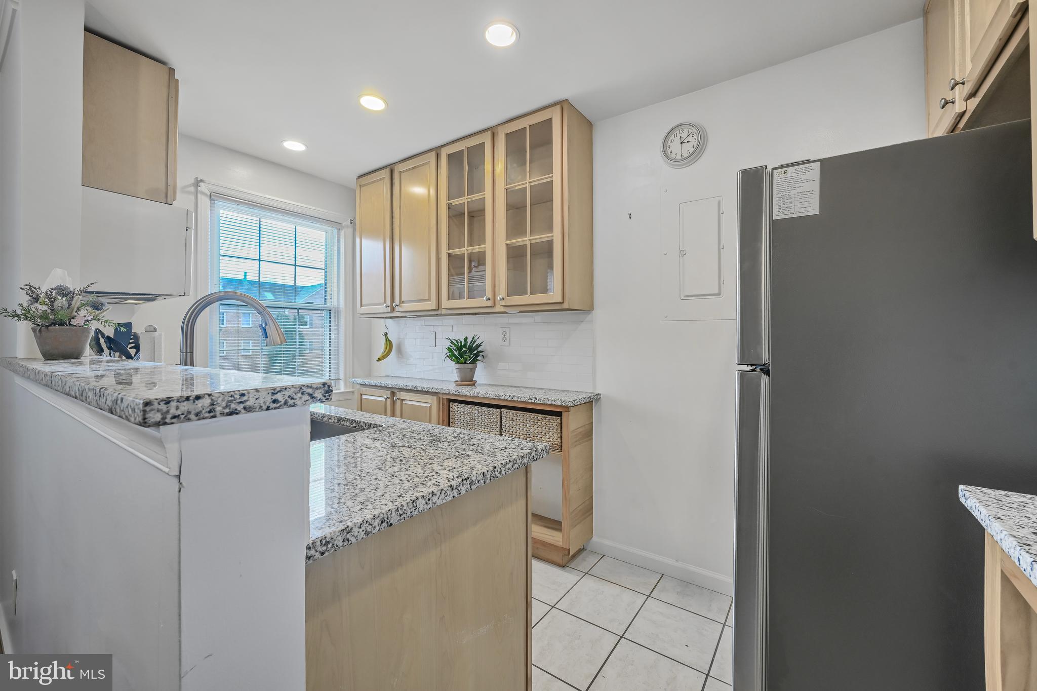 2402 Colston Drive, Unit 204 Silver Spring, MD 20910 - Photo 5 of 13 a kitchen with granite countertop a sink stove and refrigerator