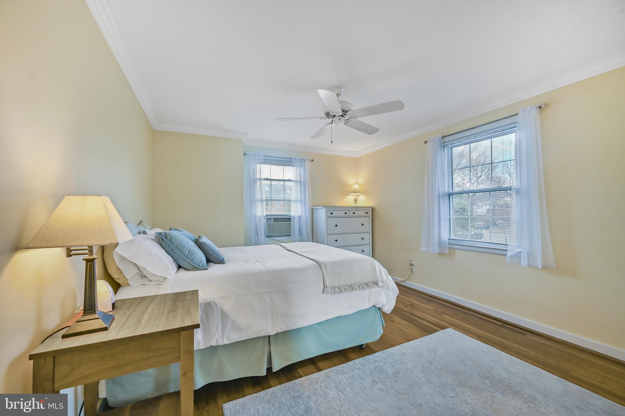 2402 Colston Drive, Unit 204 Silver Spring, MD 20910 - Photo 7 of 13 a spacious bedroom with a bed and a chandelier