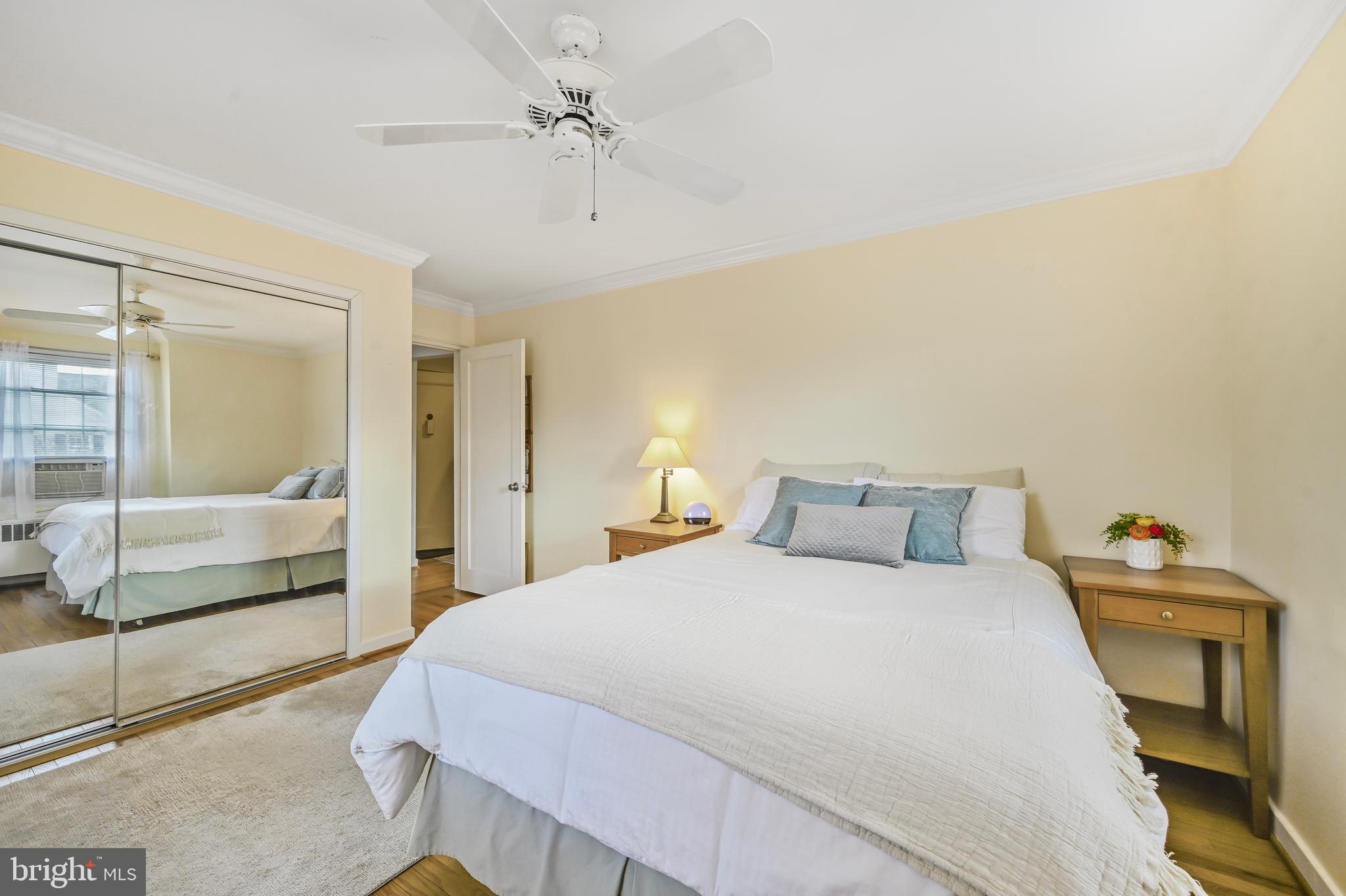 2402 Colston Drive, Unit 204 Silver Spring, MD 20910 - Photo 8 of 13 a bedroom with a bed and a large mirror