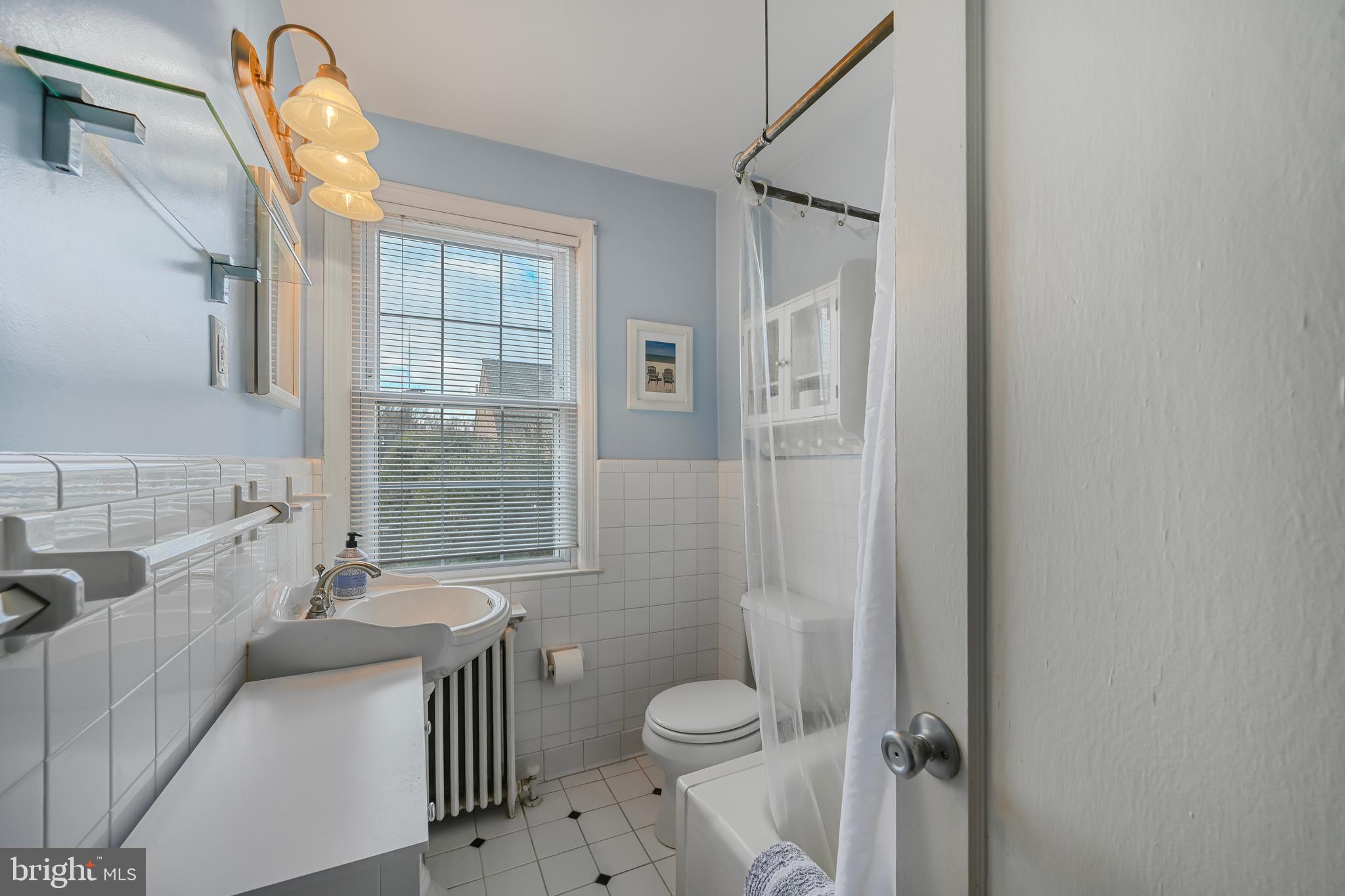 2402 Colston Drive, Unit 204 Silver Spring, MD 20910 - Photo 9 of 13 a bathroom with a granite countertop toilet a sink and a mirror