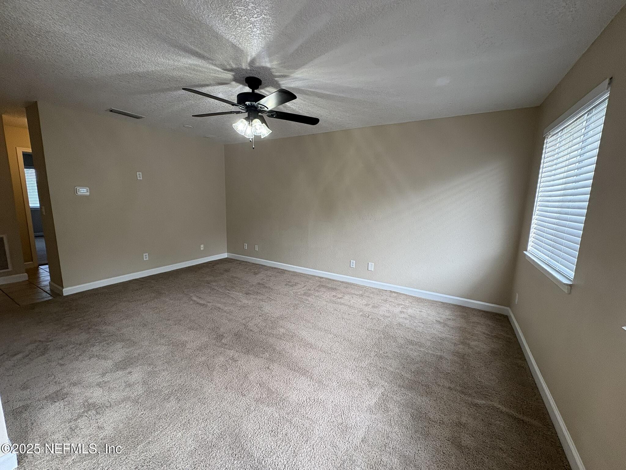 1800 Park Avenue, Unit 482 Orange Park, FL 32073 - Photo 2 of 10 an empty room with windows and fan