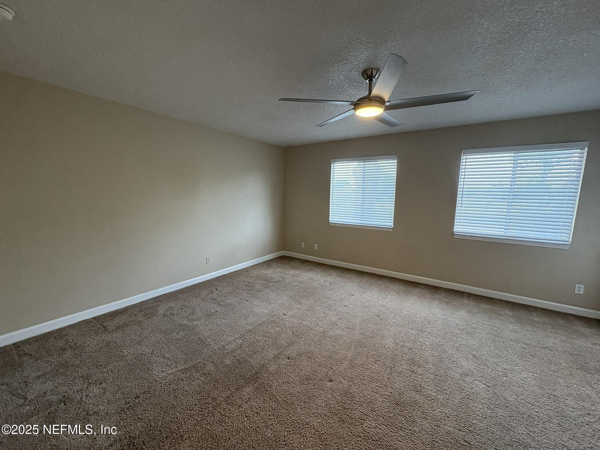1800 Park Avenue, Unit 482 Orange Park, FL 32073 - Photo 8 of 10 an empty room with windows and fan