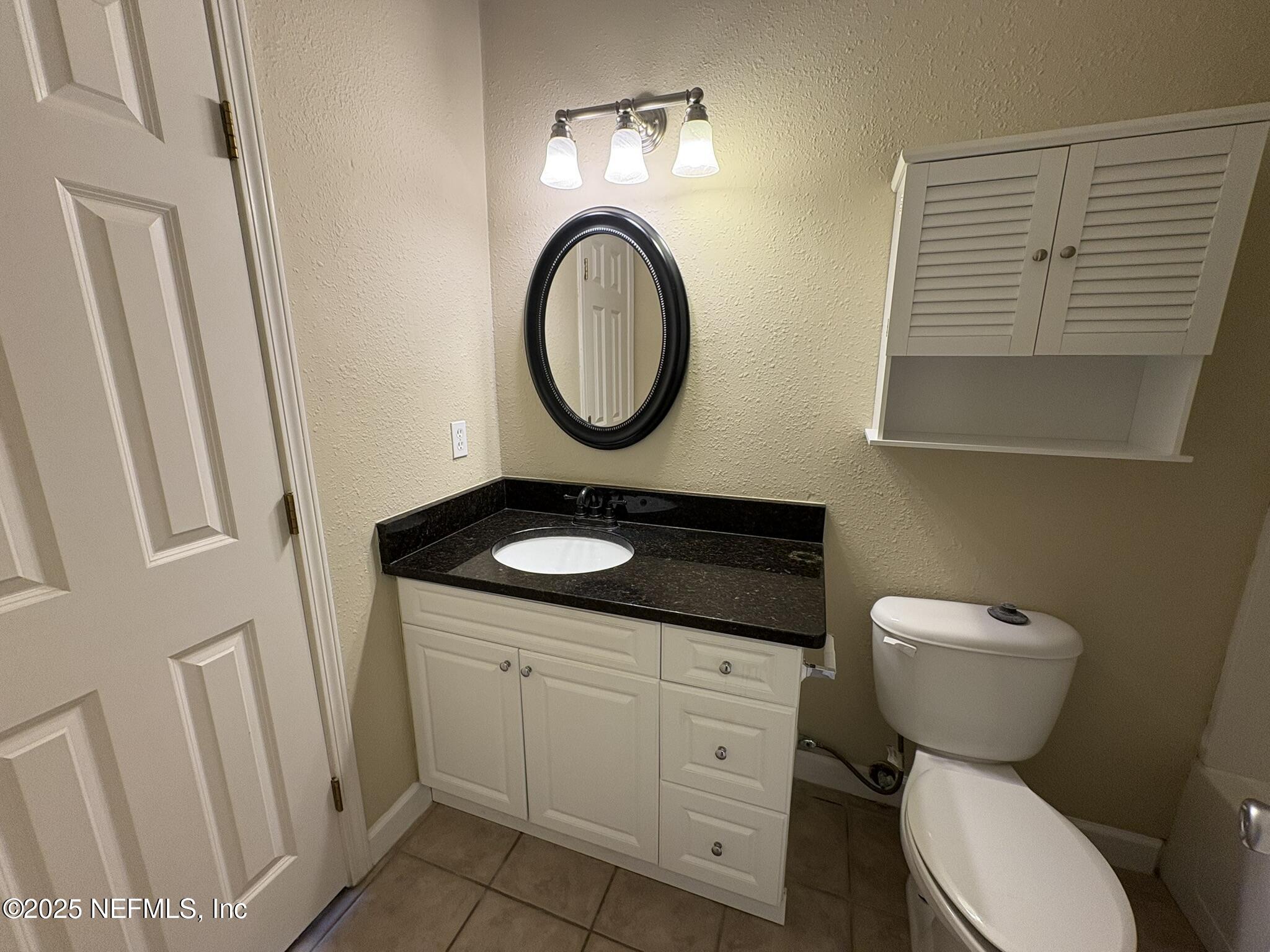 1800 Park Avenue, Unit 482 Orange Park, FL 32073 - Photo 9 of 10 a bathroom with a toilet a sink and a mirror