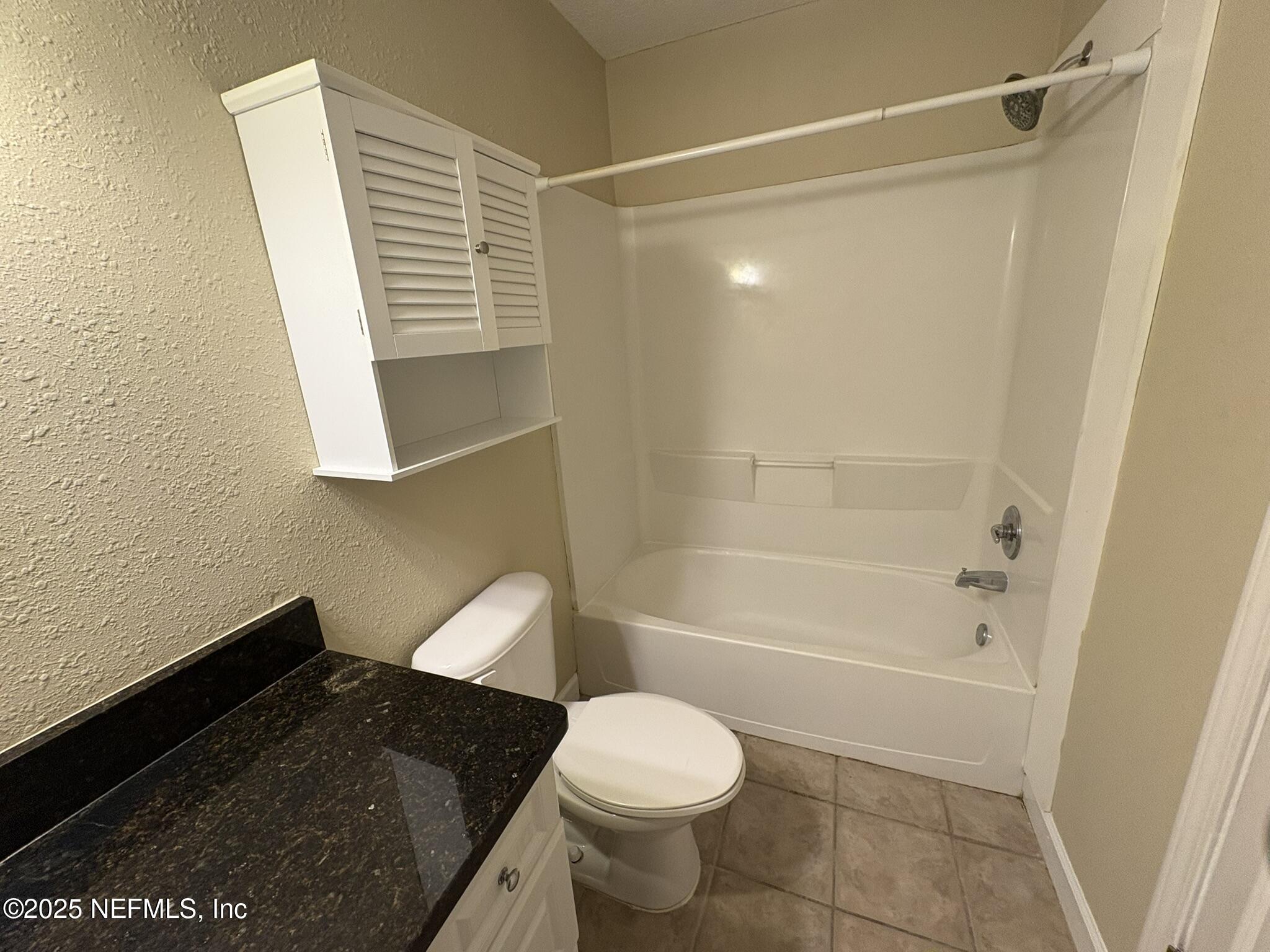 1800 Park Avenue, Unit 482 Orange Park, FL 32073 - Photo 10 of 10 a bathroom with a granite countertop sink toilet and shower