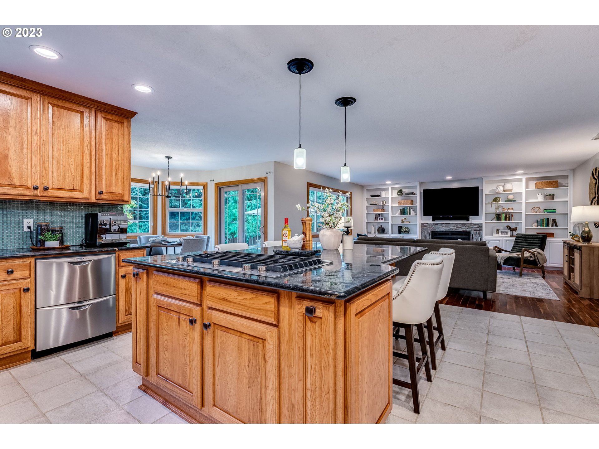 3200 Northeast Jackson Rd Loop Hillsboro, OR 97124 - Photo 16 of 37 a kitchen with granite countertop a stove a sink a dining table and chairs