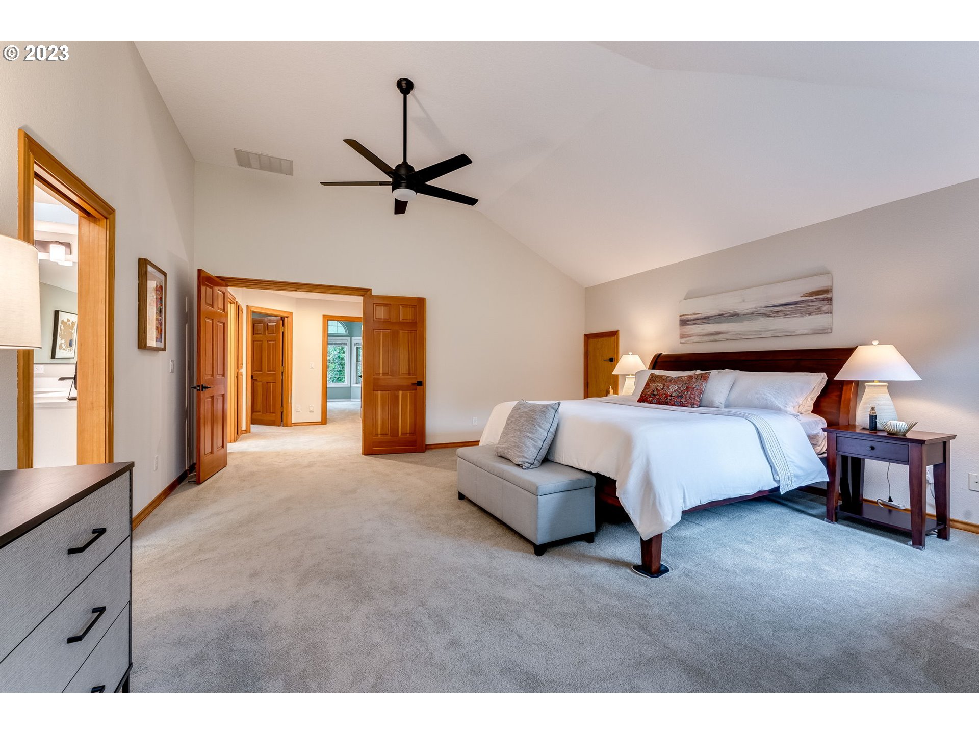 3200 Northeast Jackson Rd Loop Hillsboro, OR 97124 - Photo 28 of 37 a bedroom with a bed lamps and a large mirror
