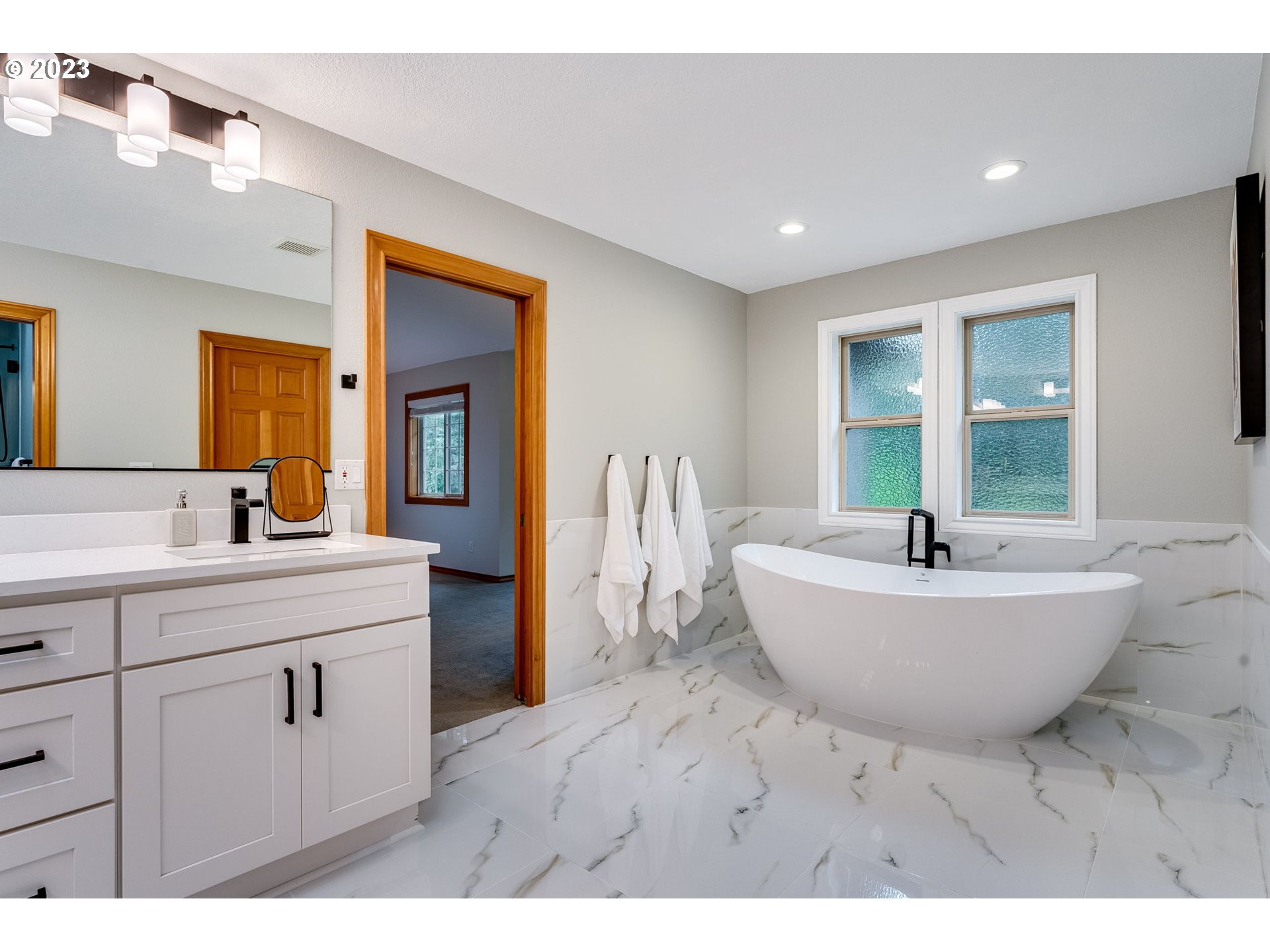 3200 Northeast Jackson Rd Loop Hillsboro, OR 97124 - Photo 30 of 37 a spacious bathroom with a tub sink and mirror