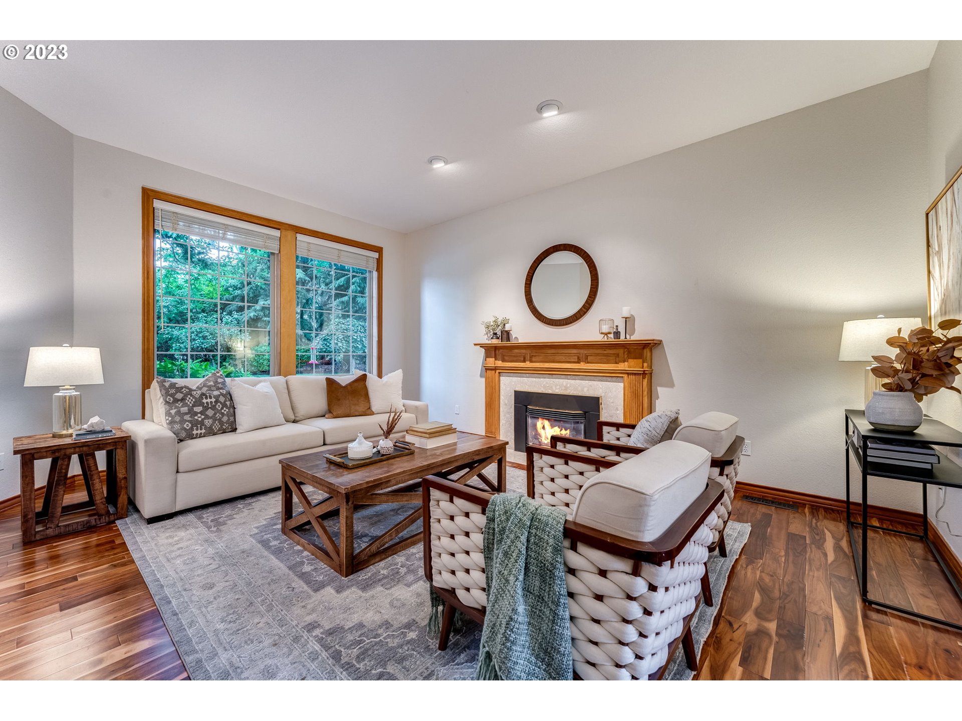 3200 Northeast Jackson Rd Loop Hillsboro, OR 97124 - Photo 7 of 37 a living room with furniture a fireplace a rug and a large window