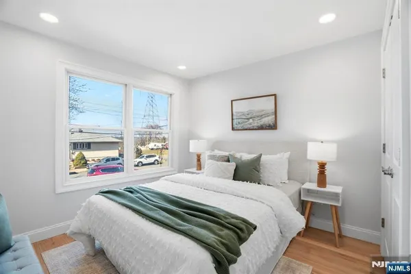 a bedroom with a bed and a painting on the wall