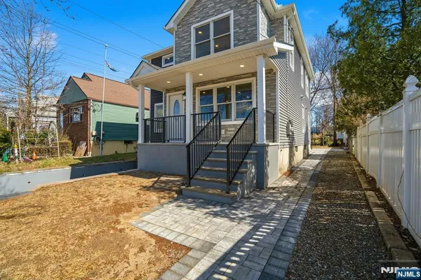 a view of a house with wooden floor next to a yard