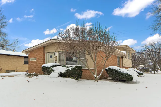 a view of a house with a snow in the yard