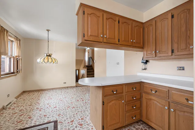 a kitchen with cabinets appliances and a wooden floor