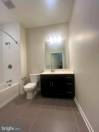 a bathroom with a toilet and a bath tub
