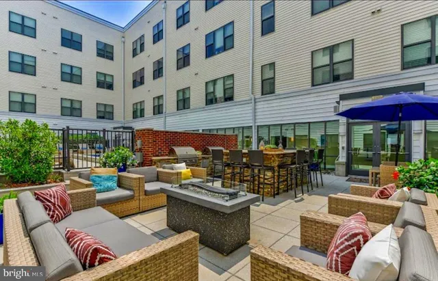a view of a patio with table and chairs and potted plants