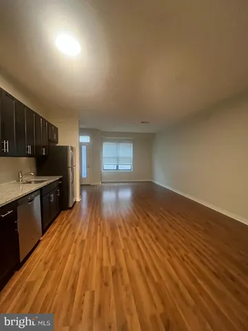 a view of hallway with wooden floor