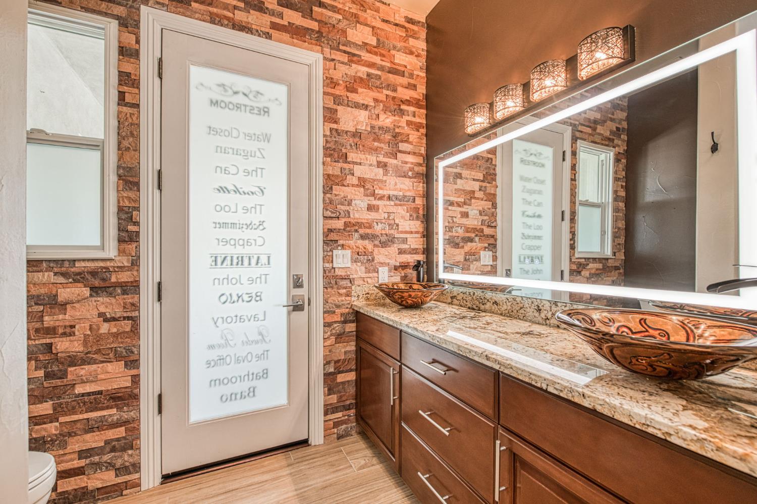 12629 Bronco Road Madera, CA 93636 - Photo 55 of 94 a bathroom with a granite countertop sink and a shower