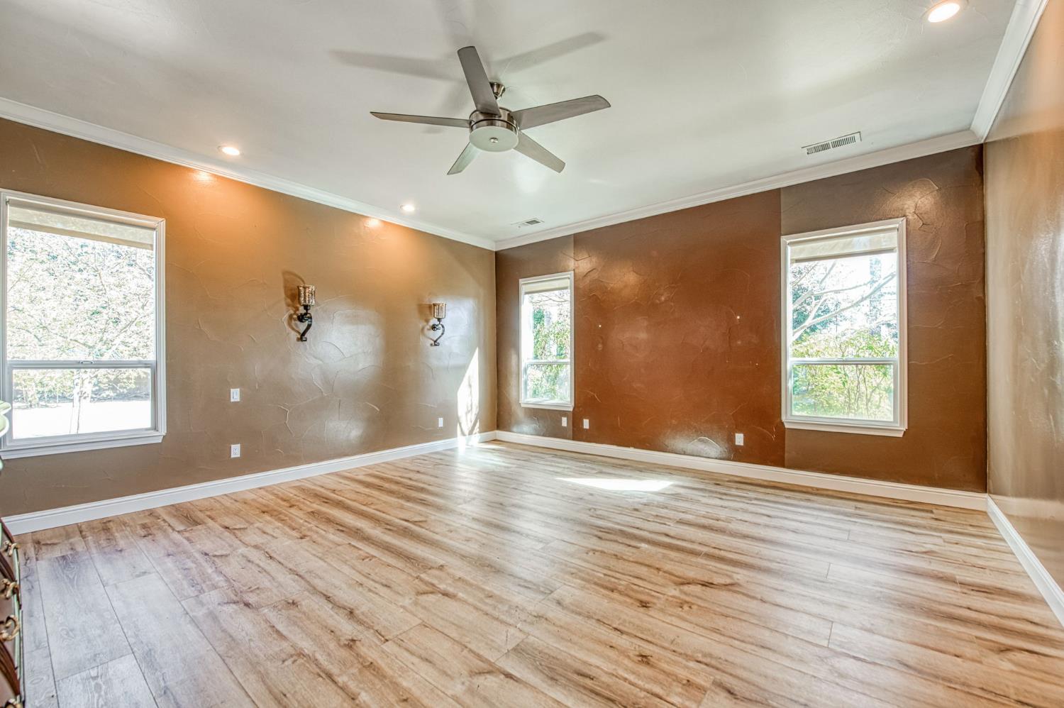 12629 Bronco Road Madera, CA 93636 - Photo 62 of 94 a view of an empty room with a window and wooden floor