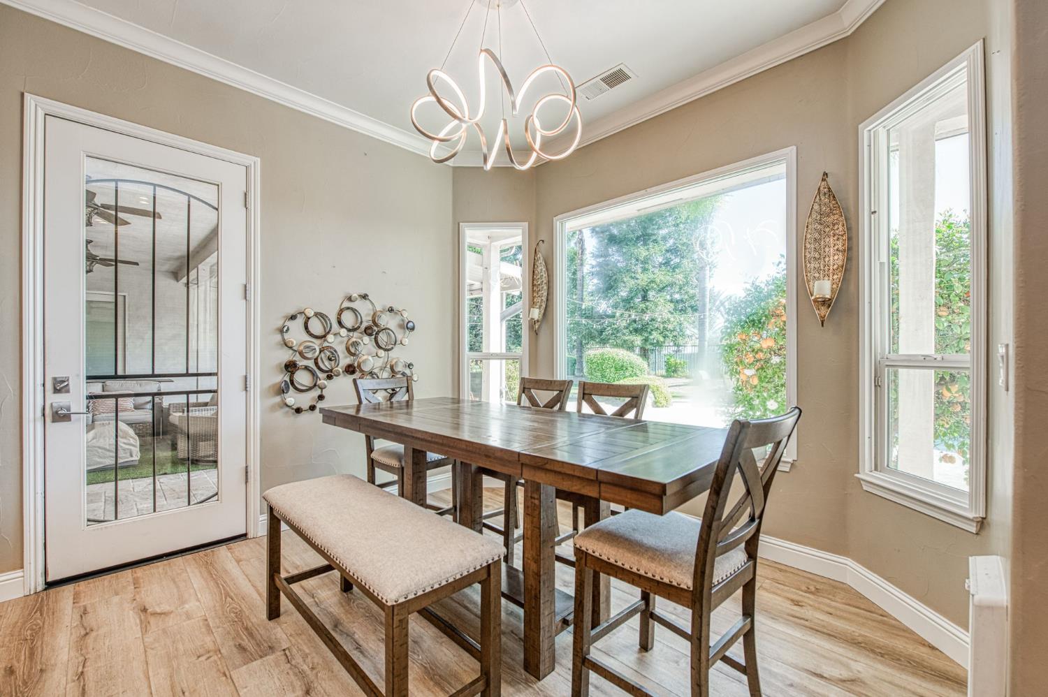 12629 Bronco Road Madera, CA 93636 - Photo 10 of 94 a view of a dining room with furniture window and wooden floor