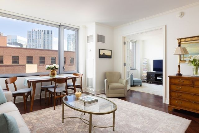 a living room with furniture a rug and a table