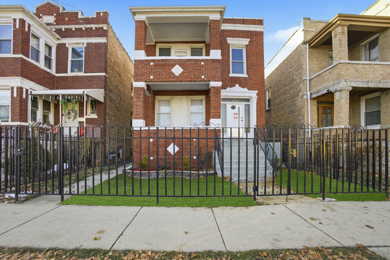 a view of a brick building next to a yard