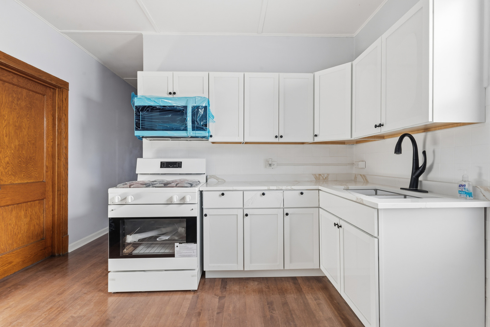 2102 South 50th Avenue Cicero, IL 60804 - Photo 19 of 53 a kitchen with stainless steel appliances white cabinets and a sink