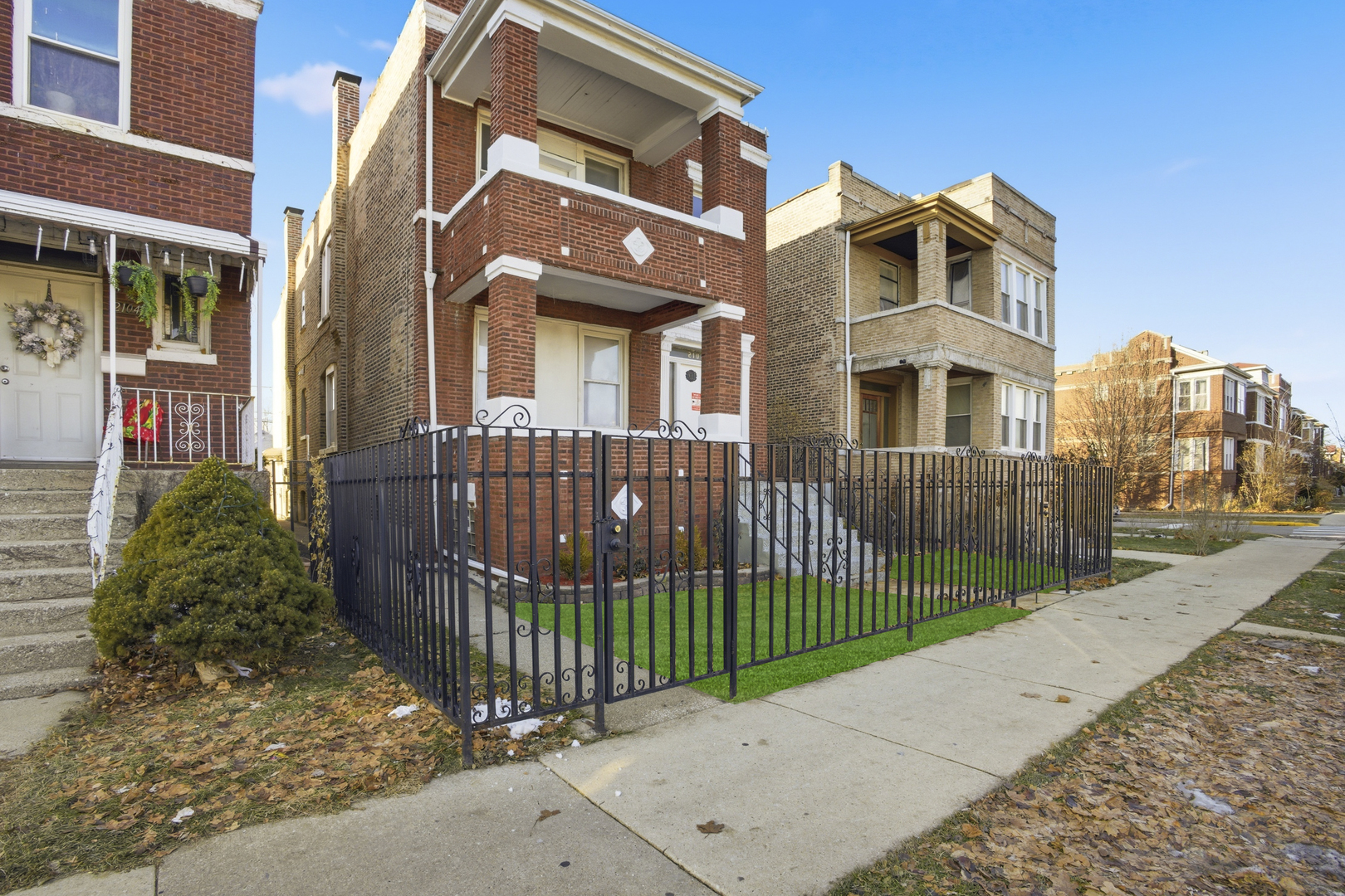 2102 South 50th Avenue Cicero, IL 60804 - Photo 2 of 53 a view of a brick house with many windows next to a road