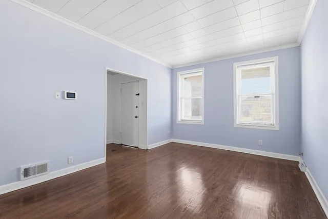 an empty room with a empty space and windows