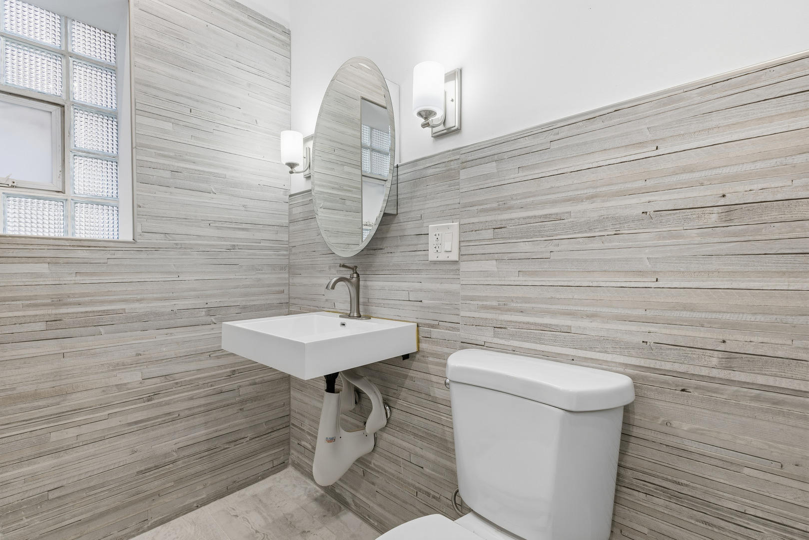 2102 South 50th Avenue Cicero, IL 60804 - Photo 31 of 53 a bathroom with a sink a toilet and mirror