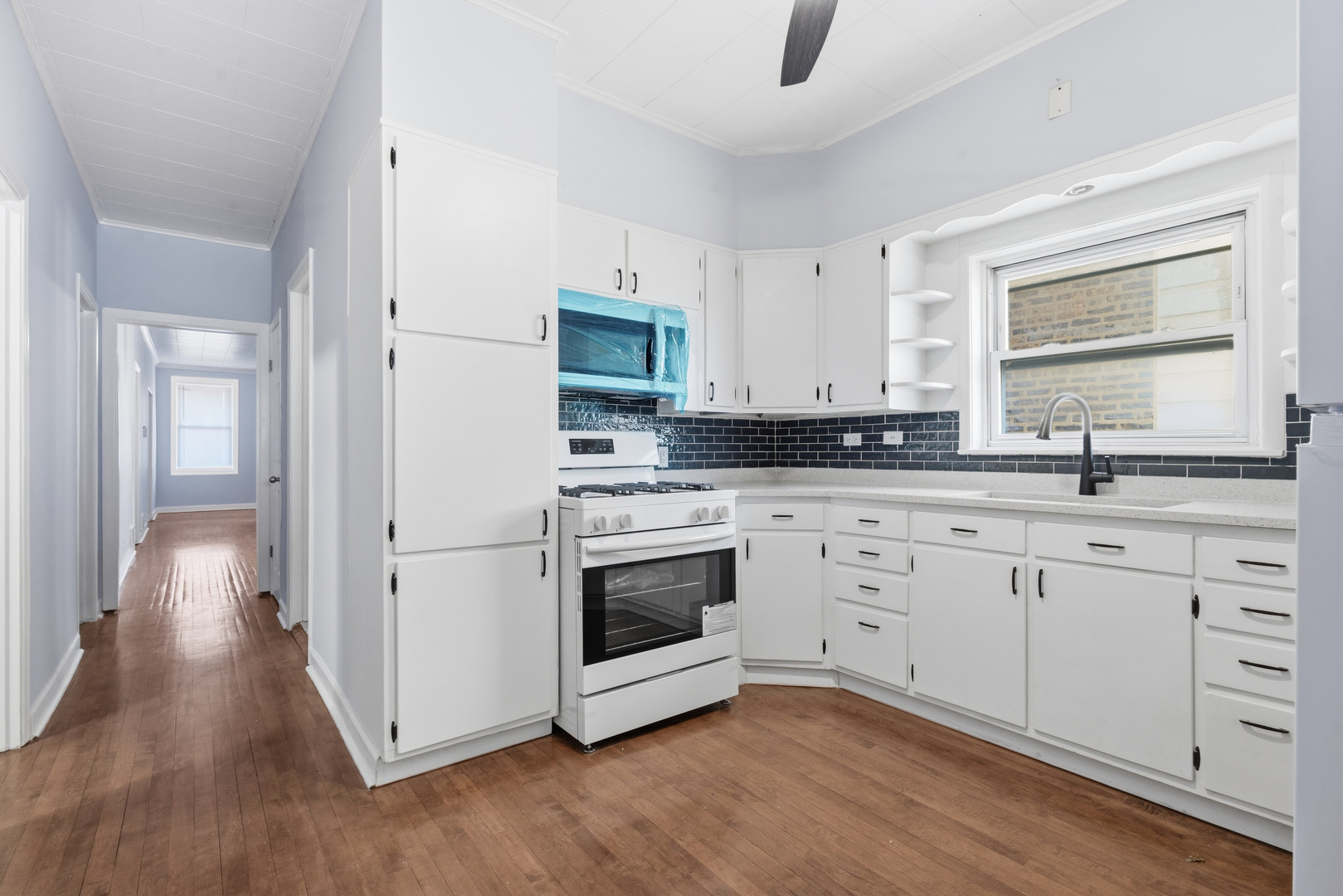 2102 South 50th Avenue Cicero, IL 60804 - Photo 33 of 53 a kitchen with stainless steel appliances a stove a sink and a refrigerator