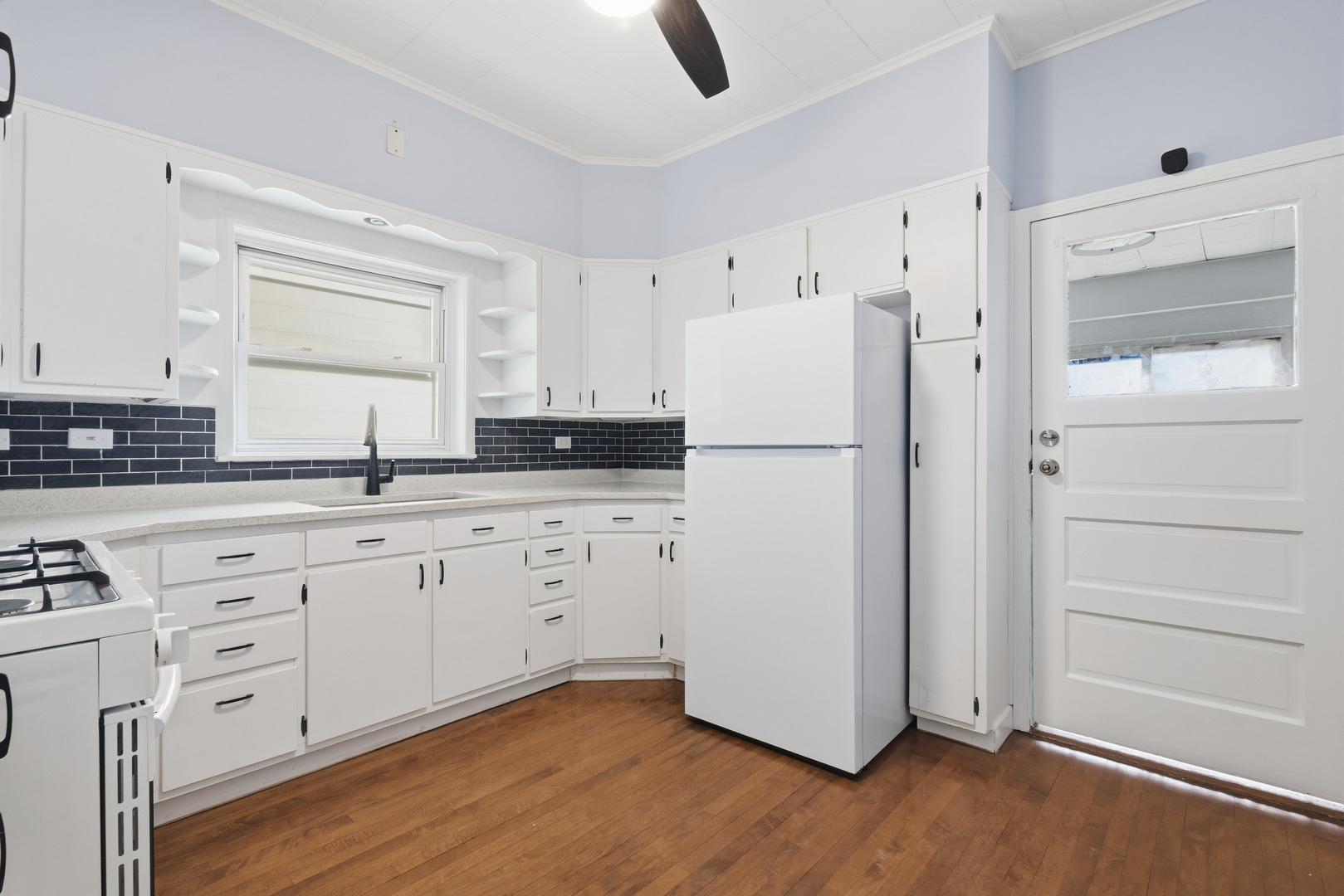 2102 South 50th Avenue Cicero, IL 60804 - Photo 34 of 53 a kitchen with white cabinets and white appliances