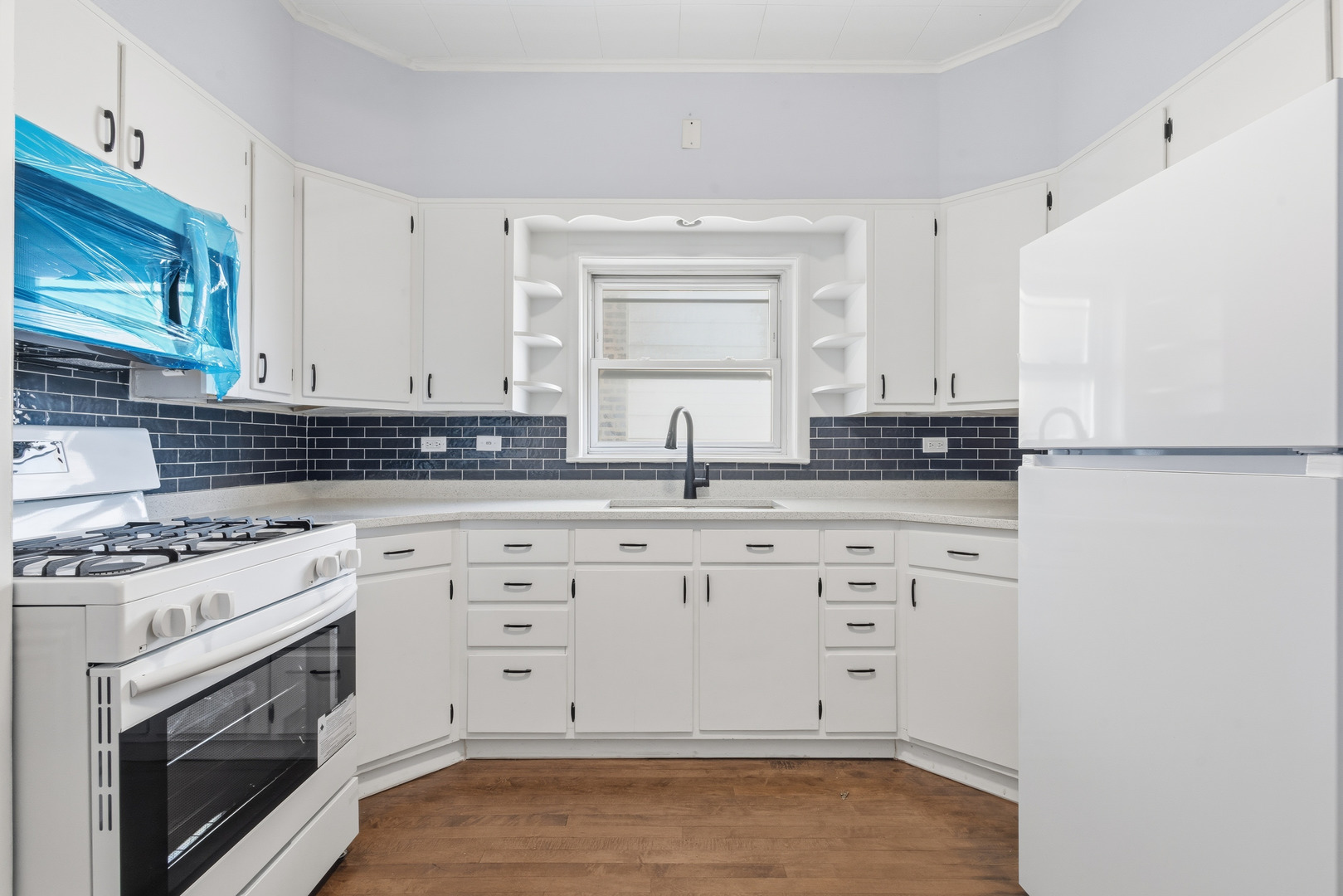2102 South 50th Avenue Cicero, IL 60804 - Photo 35 of 53 a kitchen with granite countertop white cabinets and white appliances