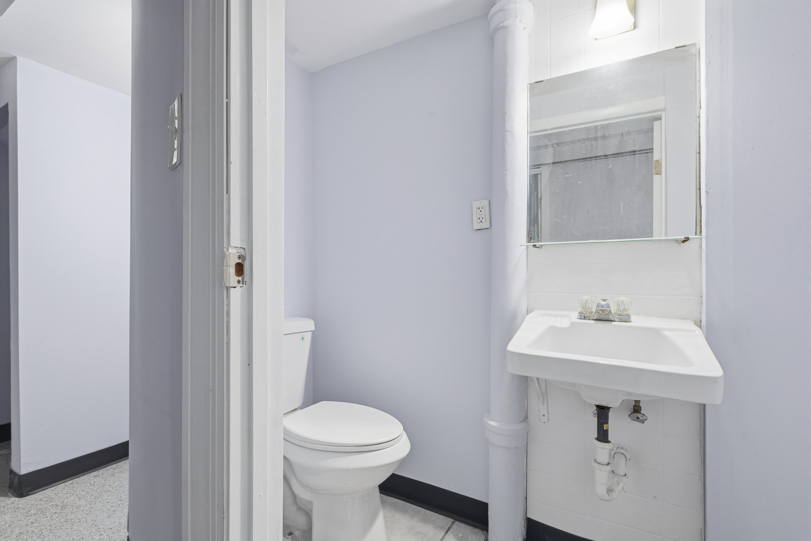 2102 South 50th Avenue Cicero, IL 60804 - Photo 42 of 53 a bathroom with a sink a toilet and a mirror
