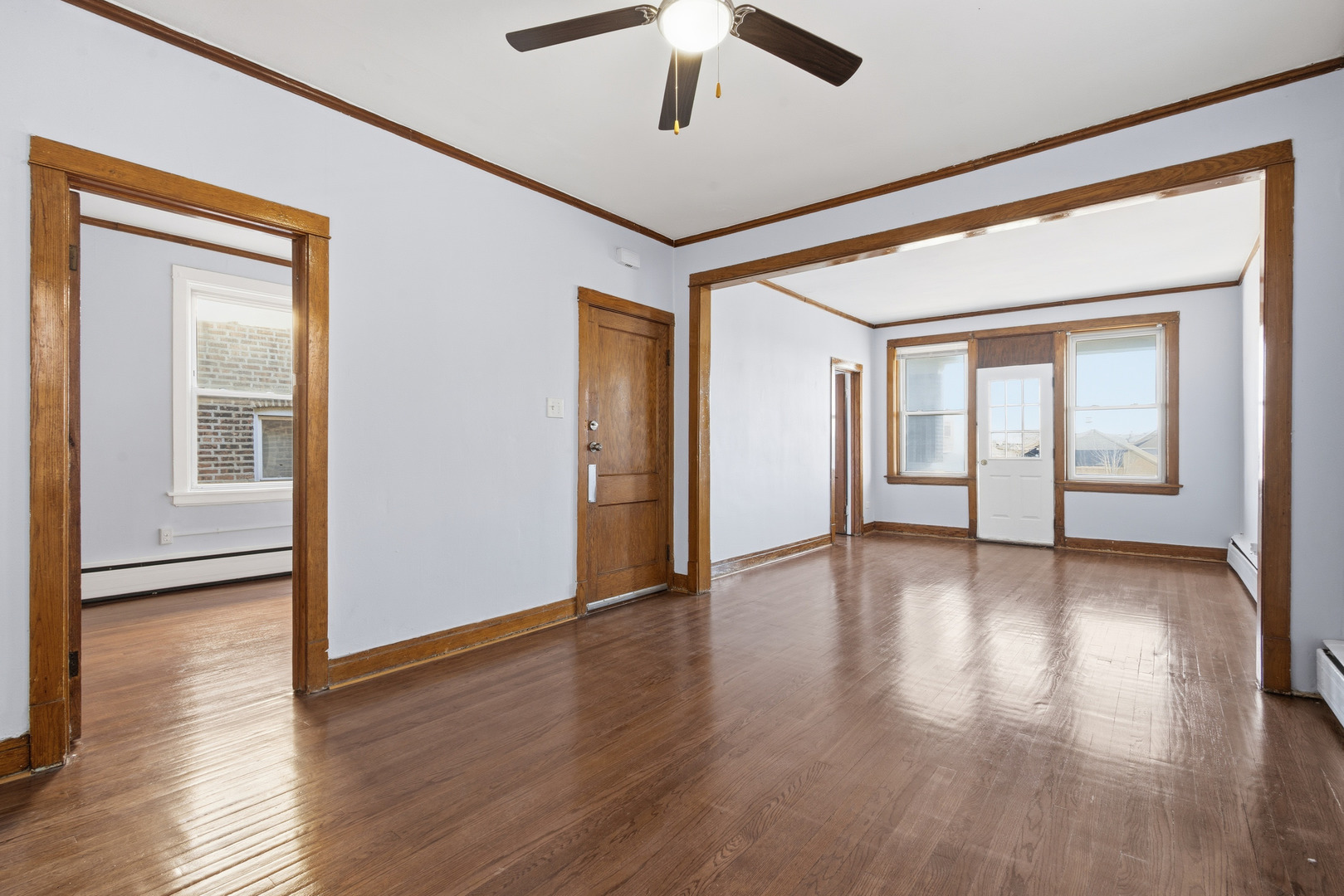 2102 South 50th Avenue Cicero, IL 60804 - Photo 7 of 53 a view of an empty room with window and wooden floor