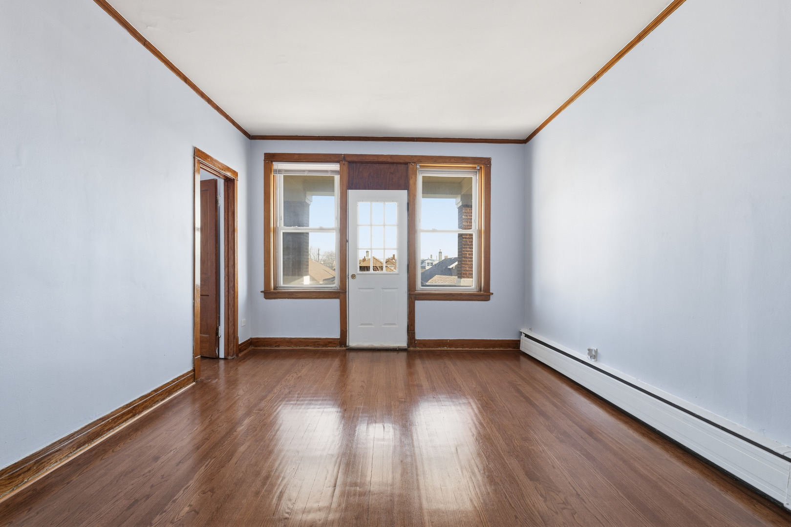 2102 South 50th Avenue Cicero, IL 60804 - Photo 8 of 53 an empty room with wooden floor and windows