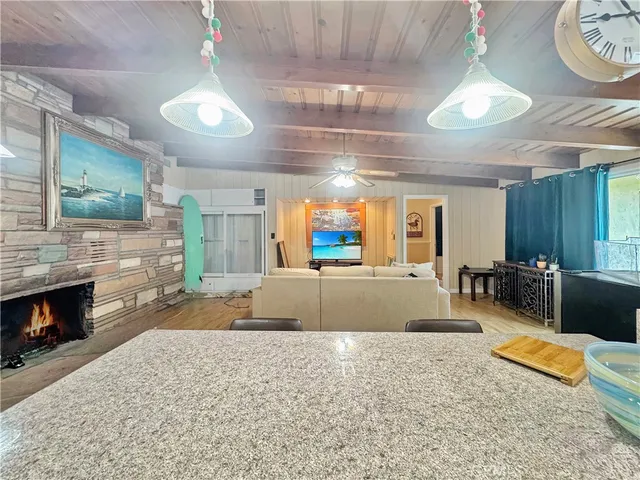 a living room with furniture a fireplace and a chandelier