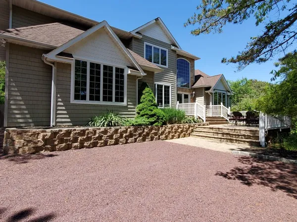 a front view of a house with a yard and outdoor seating