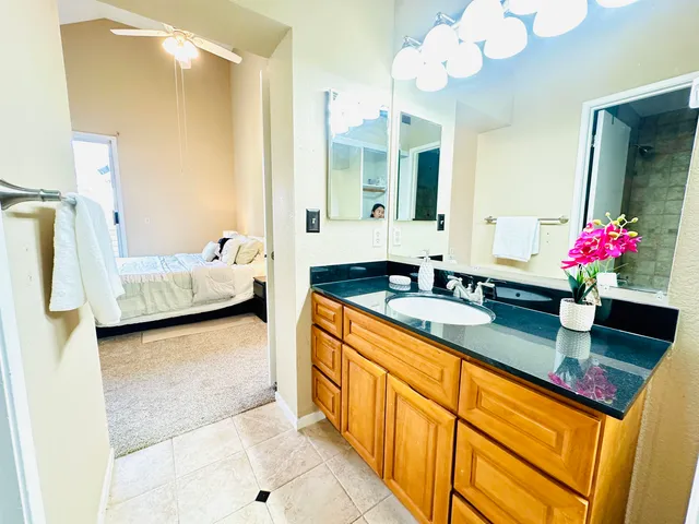 a bedroom with a bed and painting on the wall