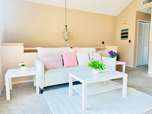 a living room with a fireplace furniture and a table