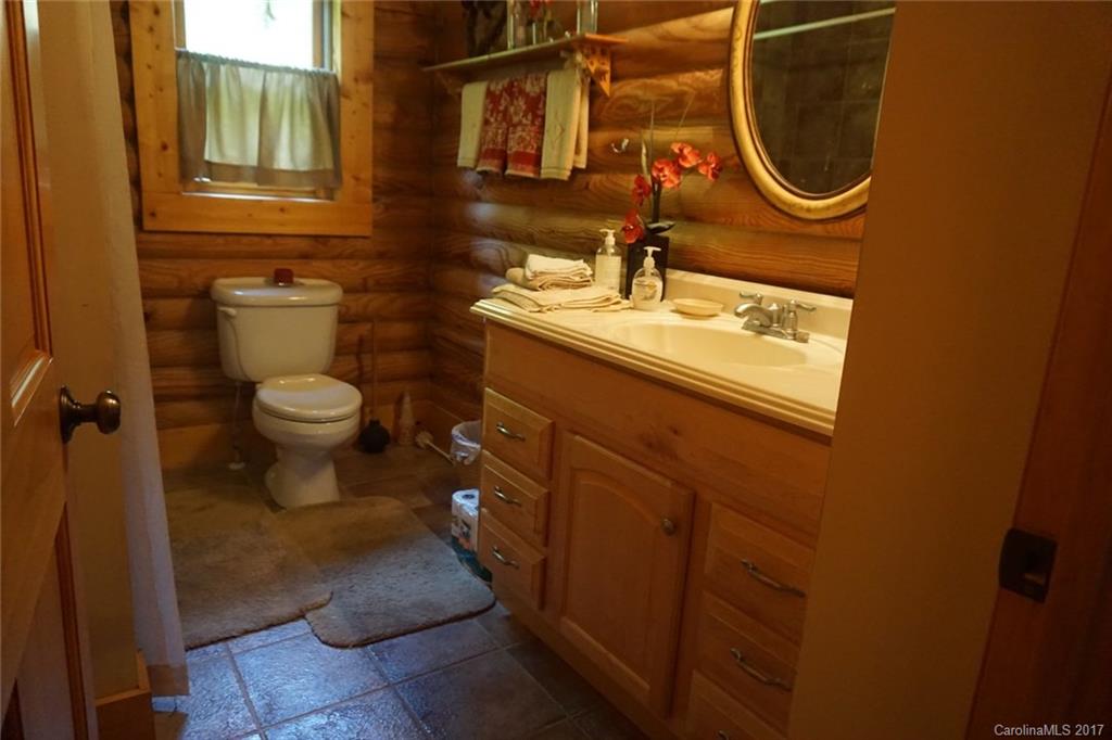 1823 Wisdom Road Lancaster, SC 29720 - Photo 12 of 23 a bathroom with a granite countertop toilet sink and mirror