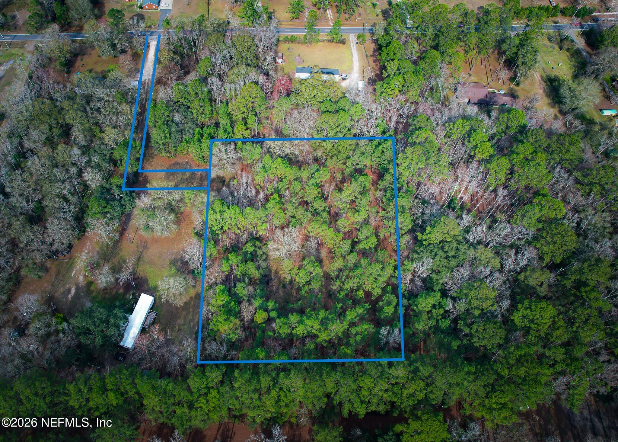 27 Ratliff Road Callahan, FL 32011 - Photo 4 of 21 an aerial view of a house with a yard and large trees