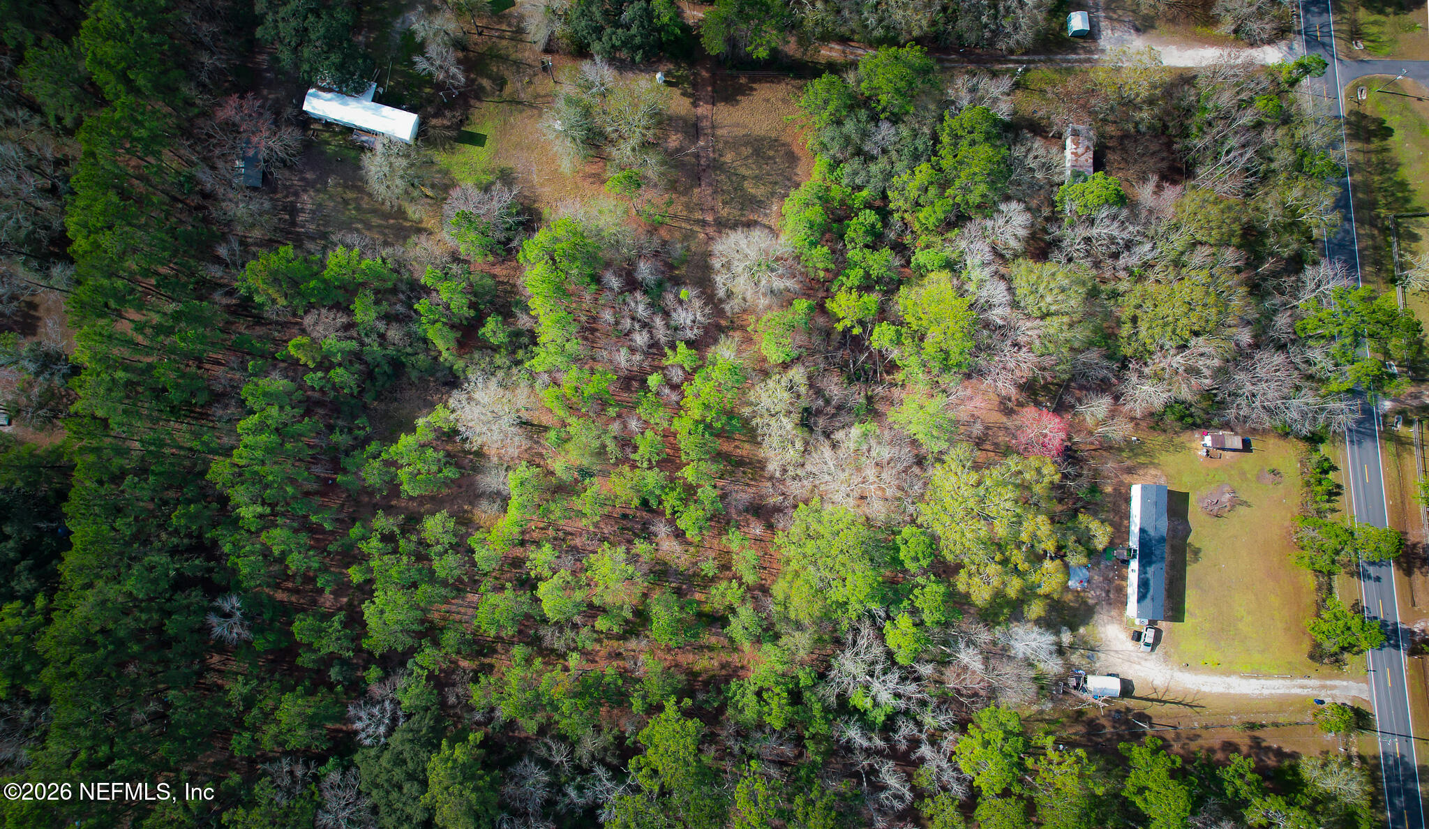 27 Ratliff Road Callahan, FL 32011 - Photo 7 of 21 an aerial view of residential house with outdoor space and trees all around