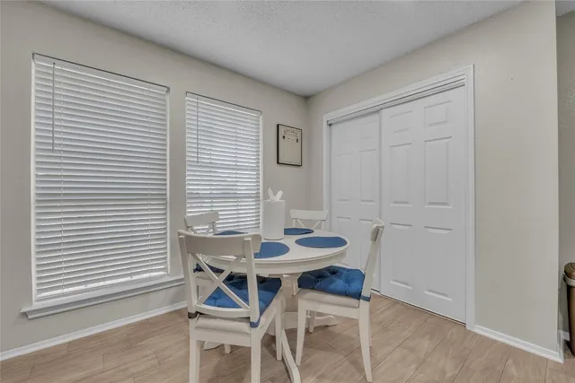 a view of a dining room with furniture and wooden floor