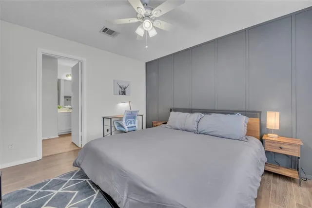 a bedroom with a bed and a lamp