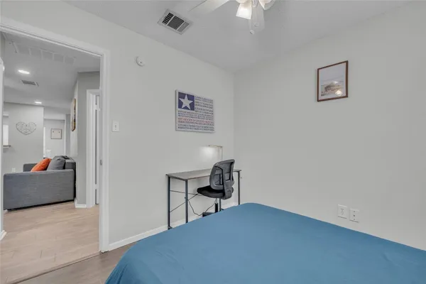 a bedroom with a bed and a couch